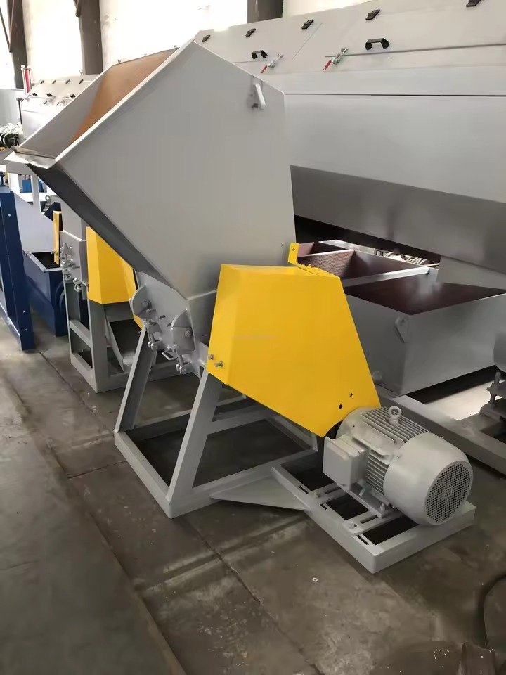 Plastic waste collection point in Manila with piles of PET bottles ready for recycling