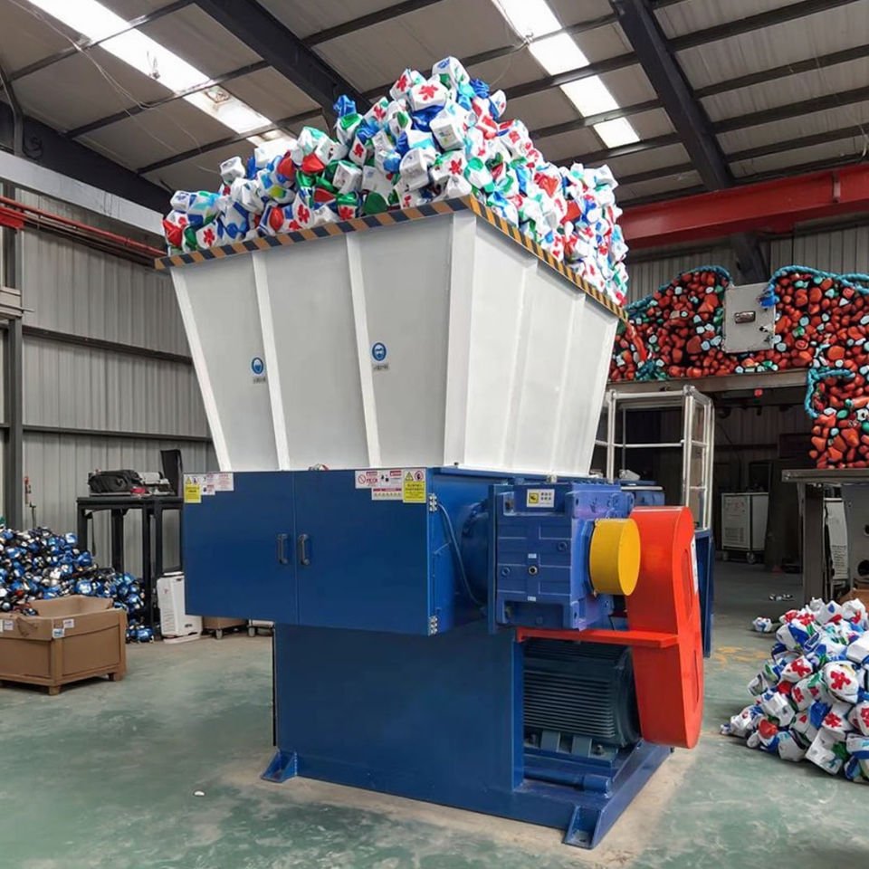 Industrial plastic shredder machine processing plastic waste in recycling facility